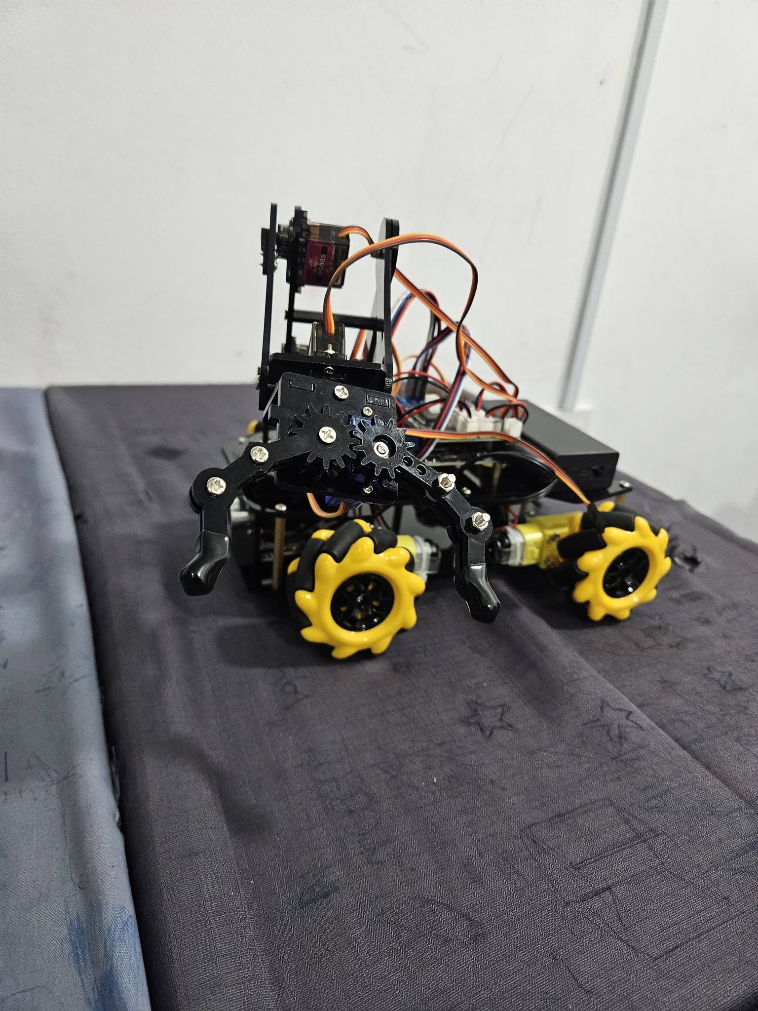 A completed robotics vehicle with a gripper mechanism from the kids robotics program