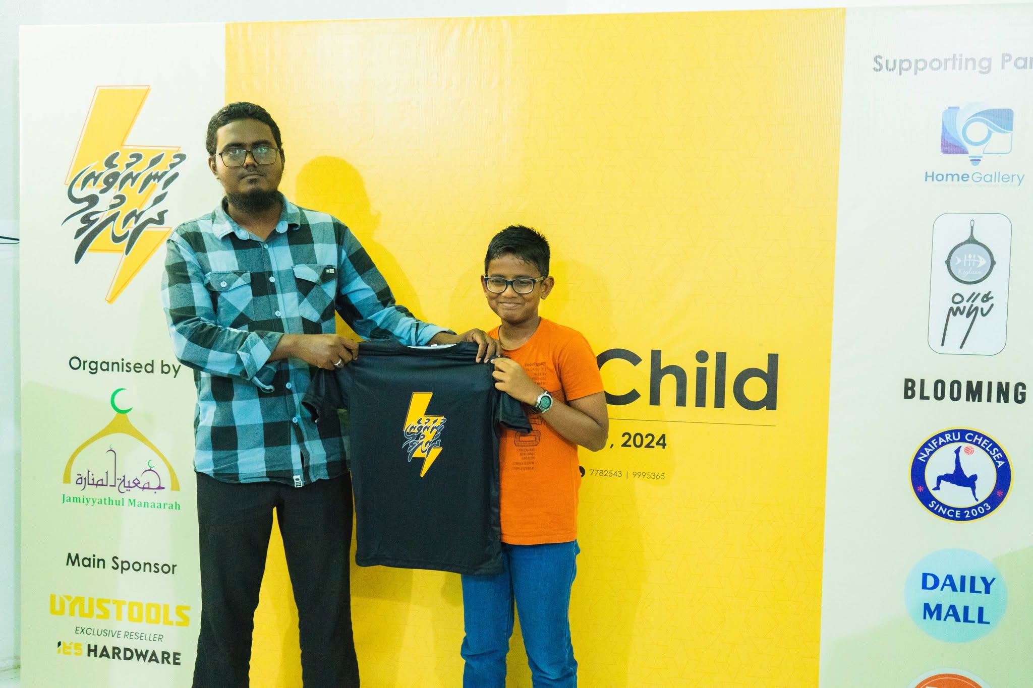A learner receiving a The Talented Child MV shirt at a program event